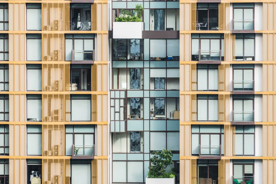Repeating balconies and glazing across an apartment facade